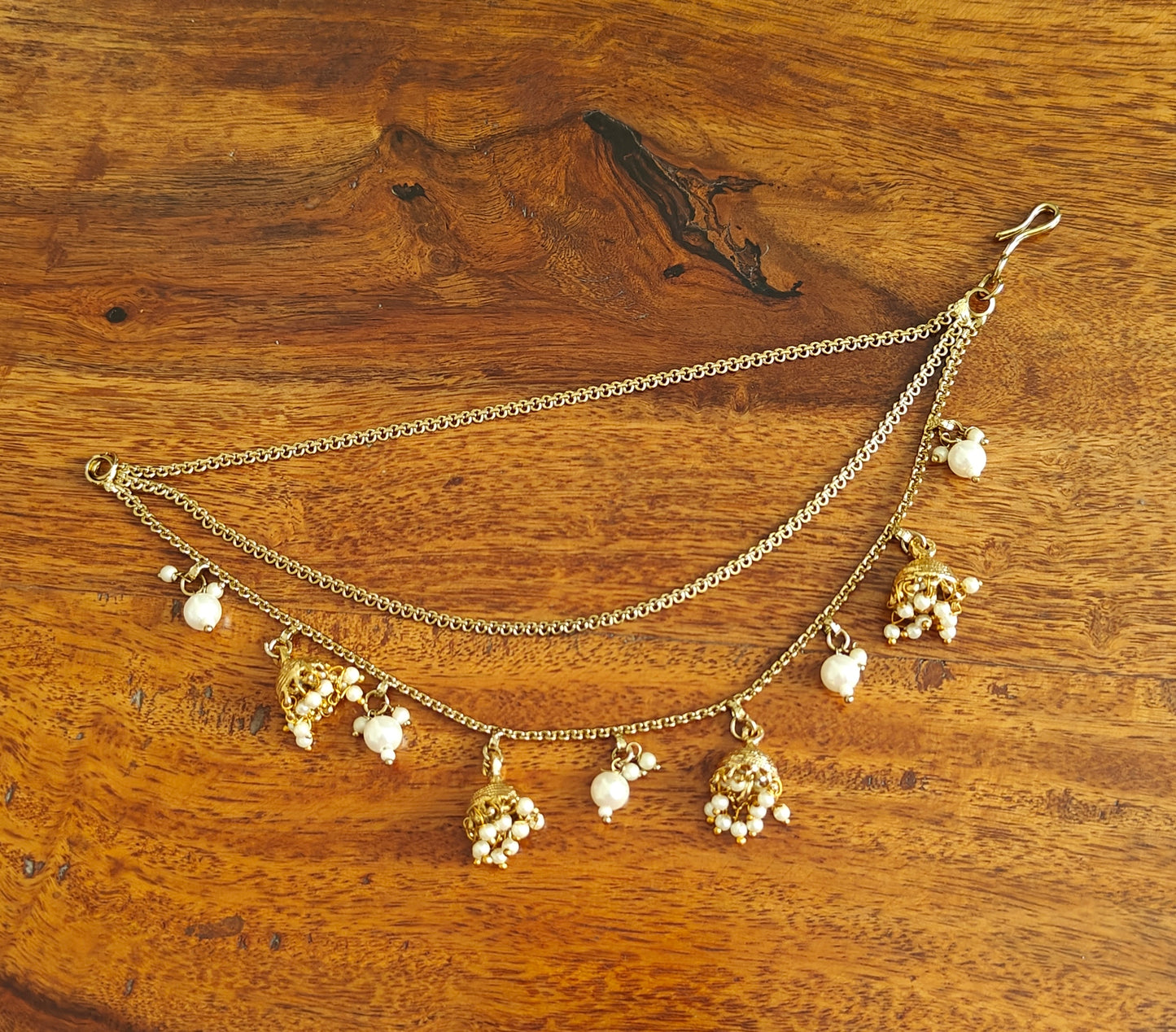 Antique gold finish earchains with jhumkis pearl clusters