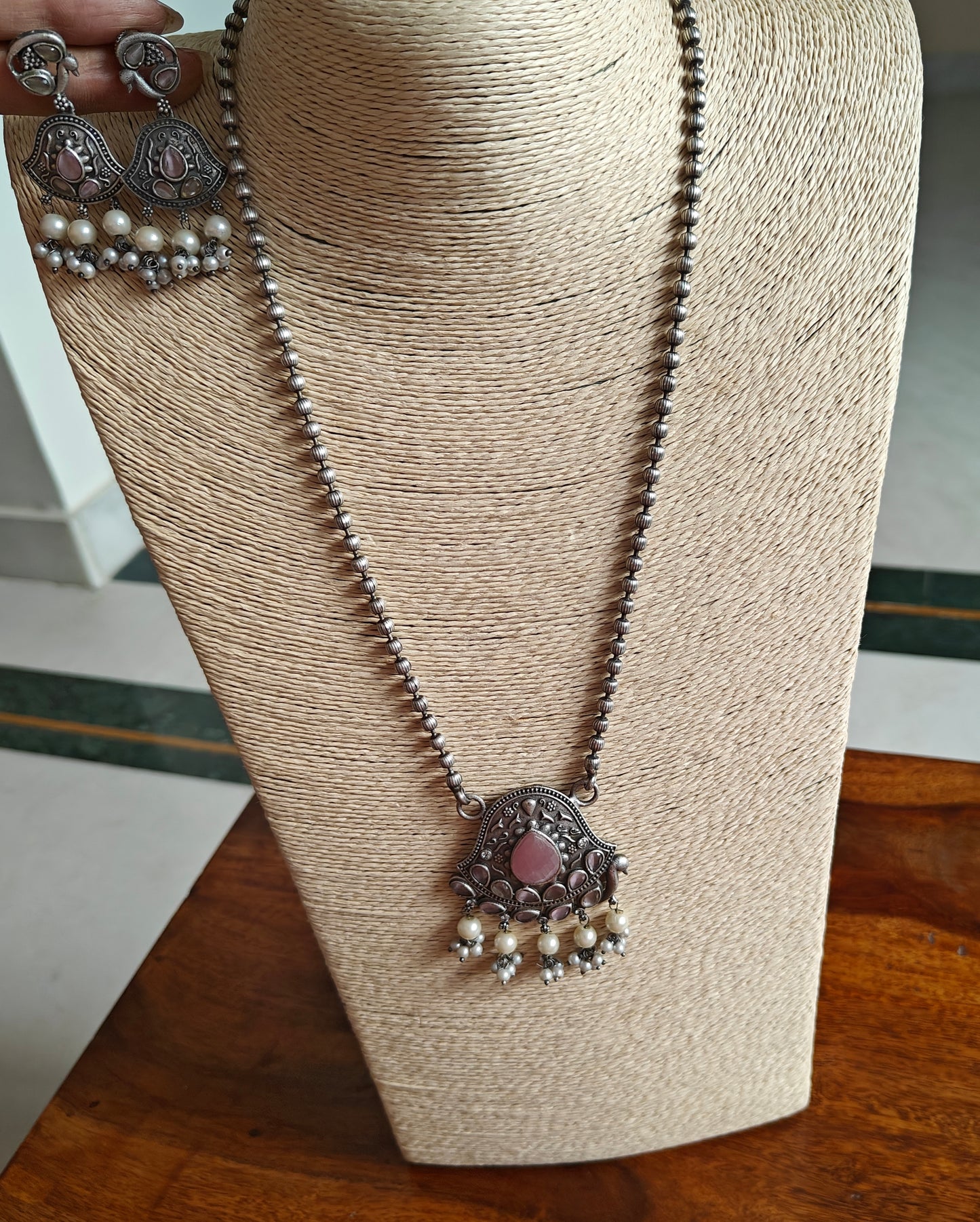 Set with peacock motif and stones
