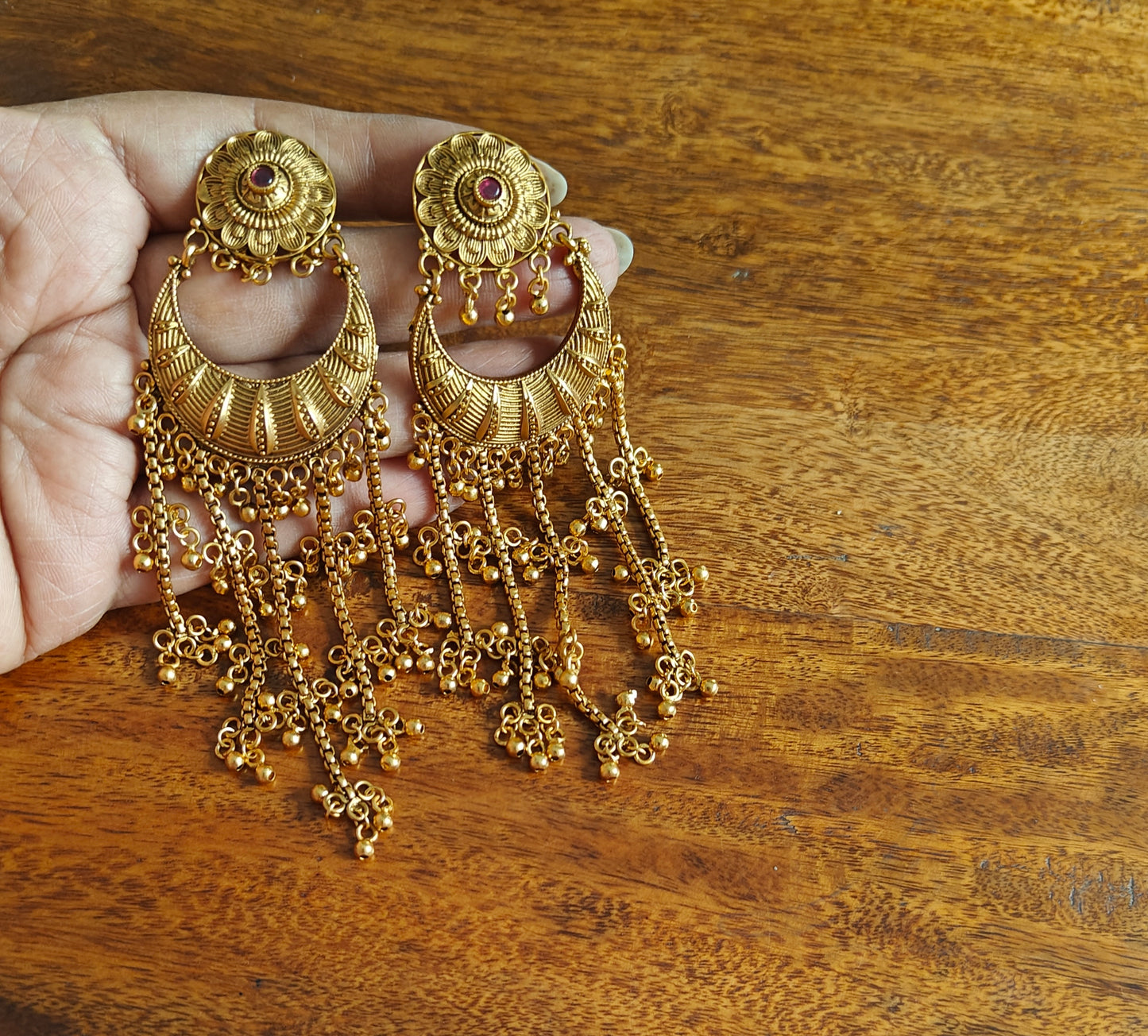 Gold earrings with gold ball hangings on five chains