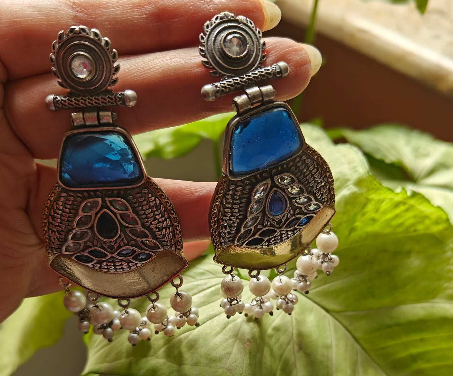Dual tone earrings with emerald blue stone and pearl hangings