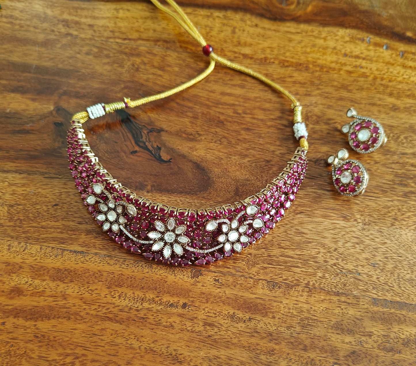 Swagata set with Ruby red stones and moissanite flowers on top