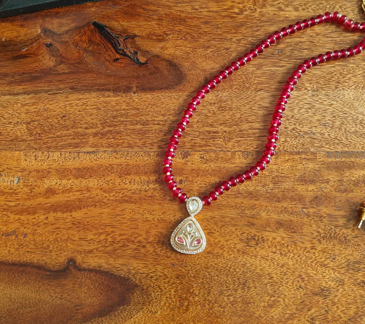 Radhana set with stone string and moissanite on shell.