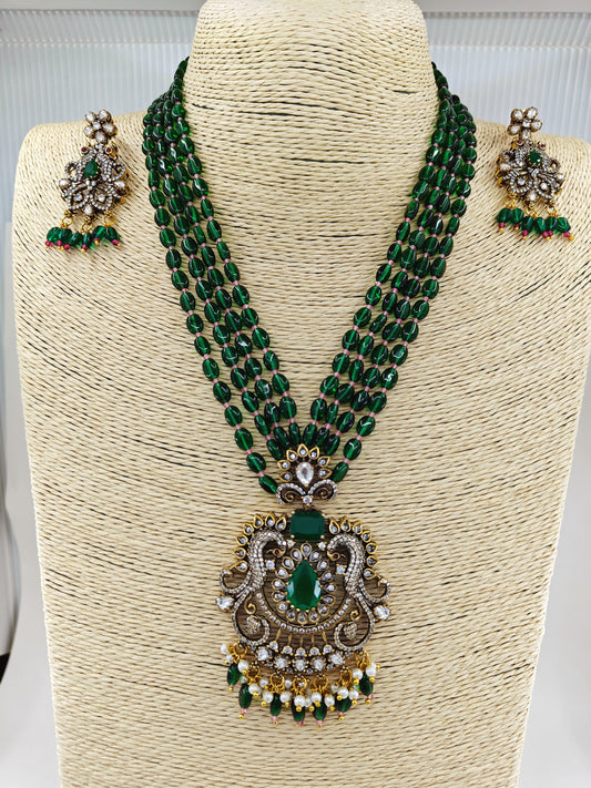 Antique finish set in kundan,CZ and green emerald stone