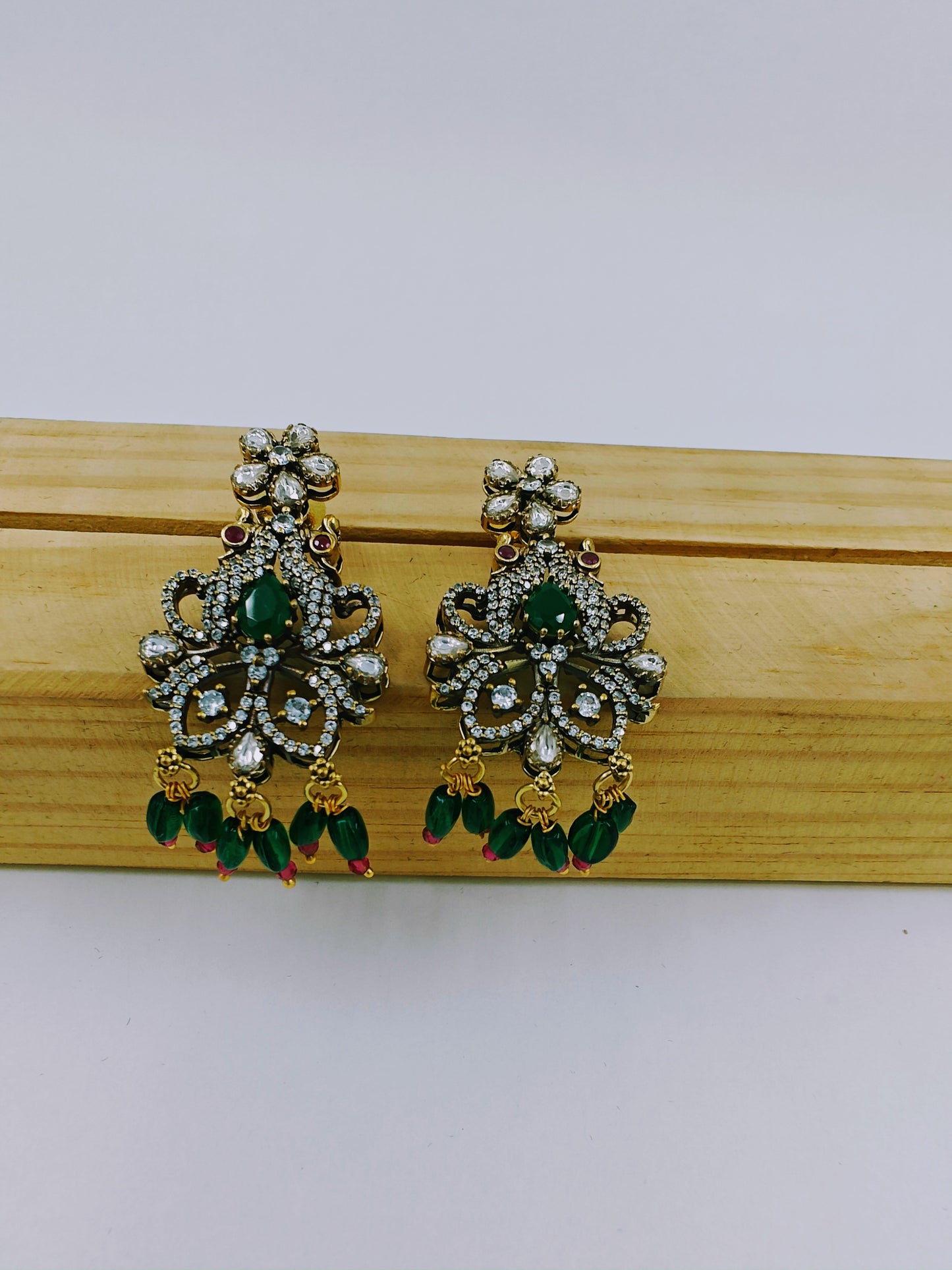 Antique finish set in kundan,CZ and green emerald stone