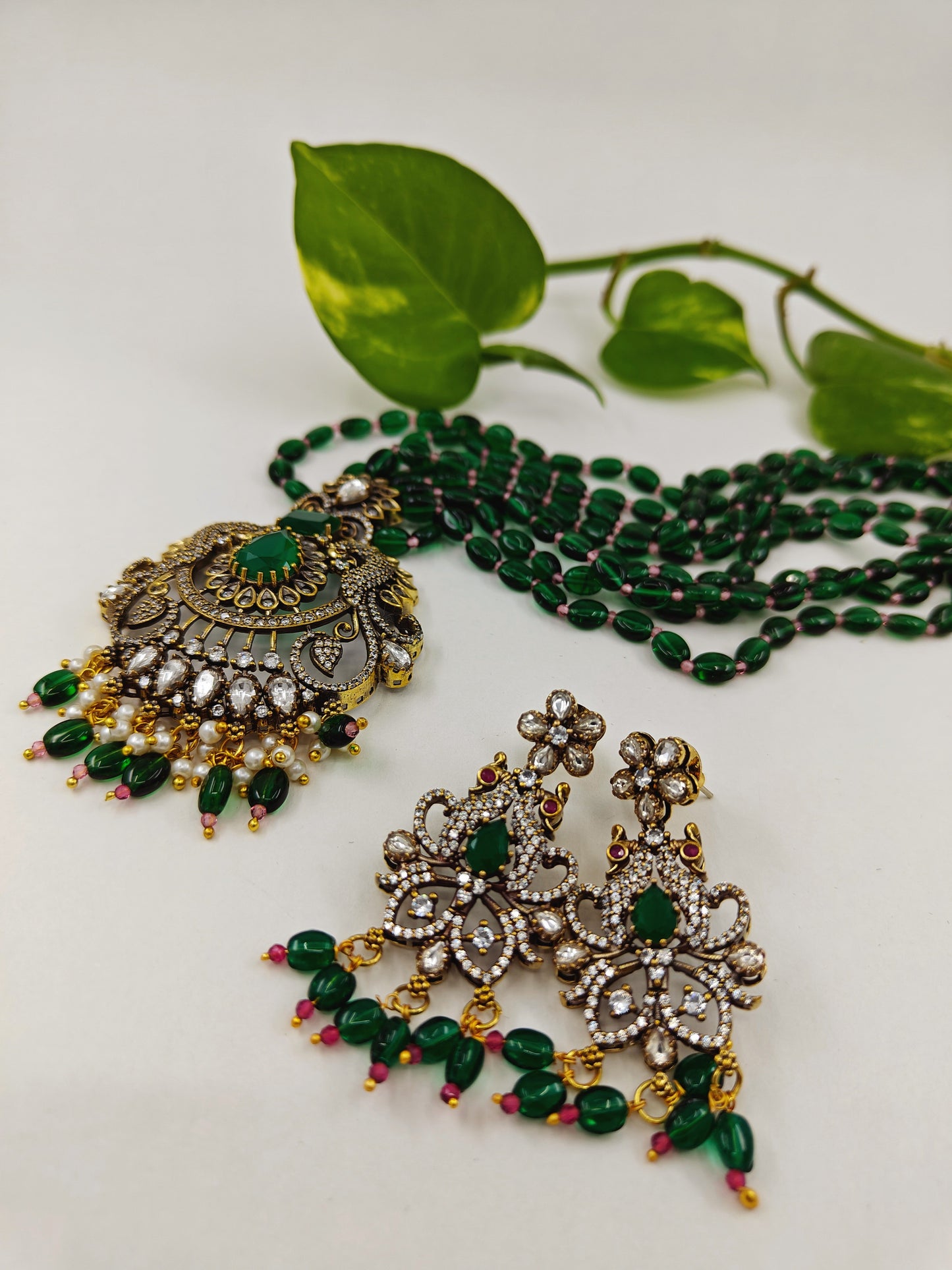 Antique finish set in kundan,CZ and green emerald stone