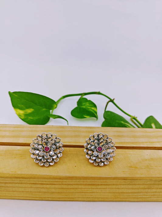 Silver earrings in open flower motif with clear stones