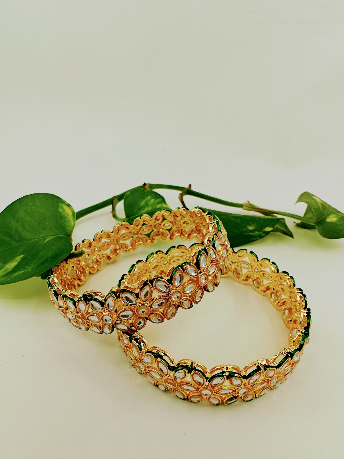 Bangles/ karas in gold finish with flower motif all around(2pcs)