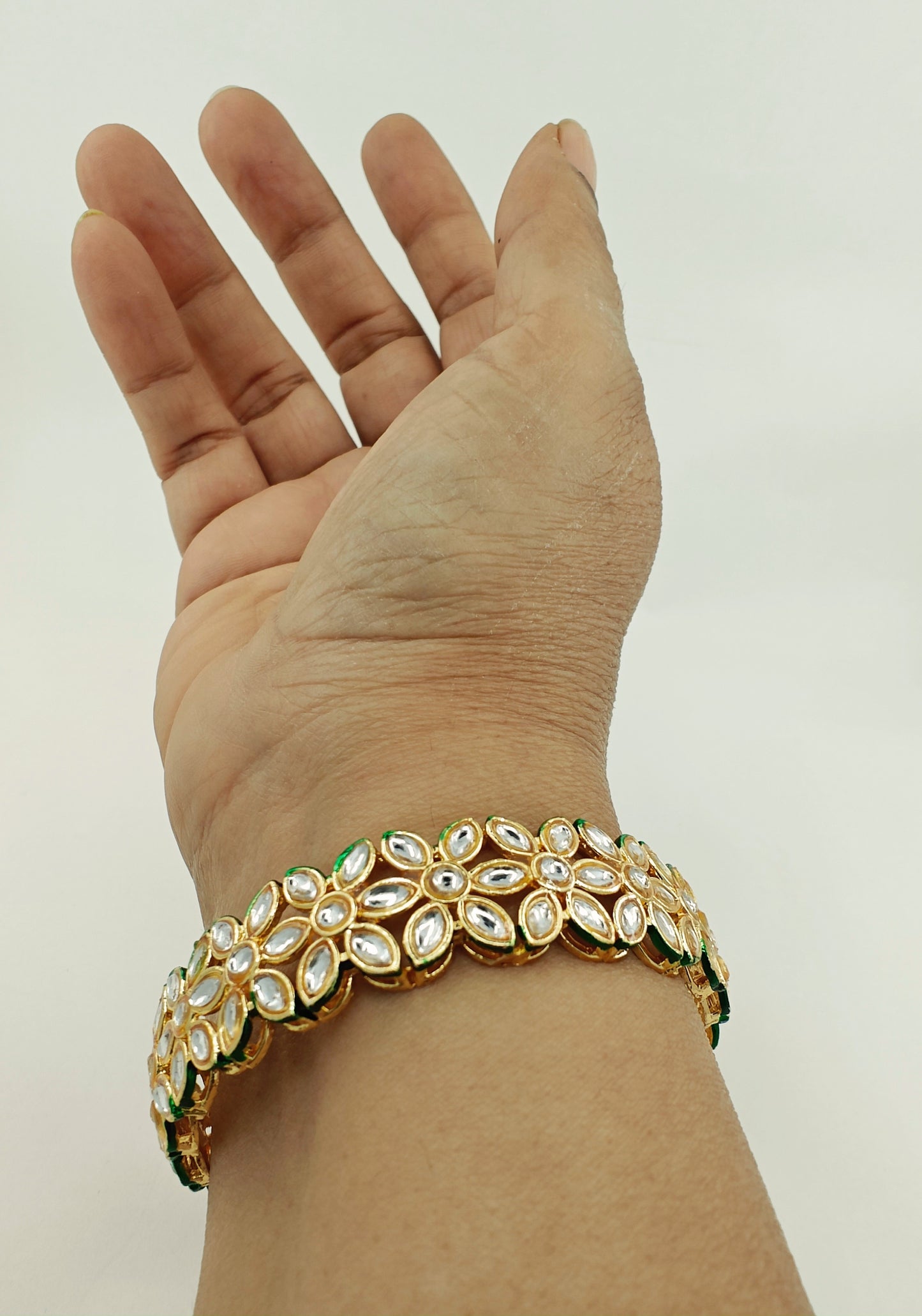 Bangles/ karas in gold finish with flower motif all around(2pcs)