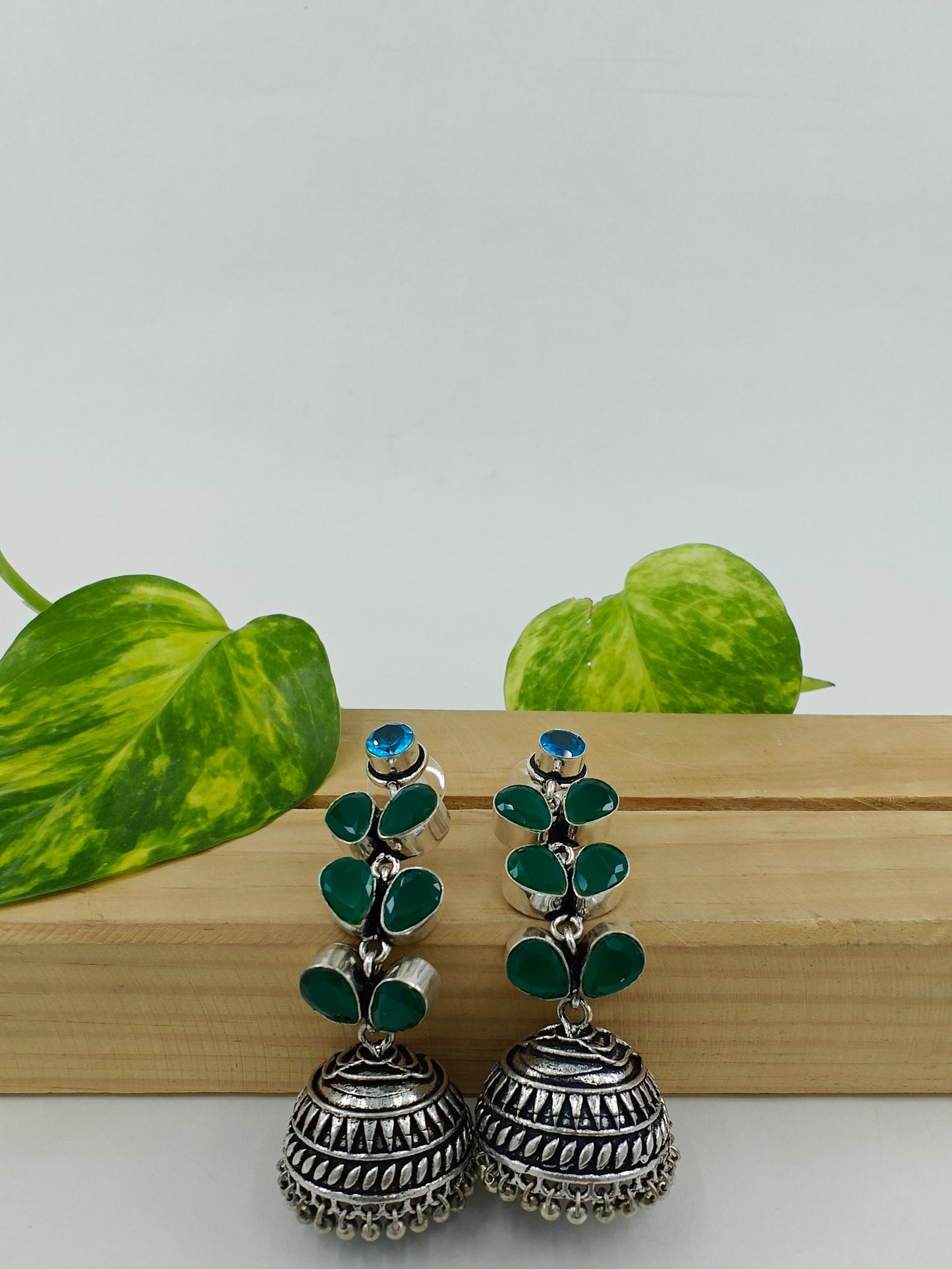 Silver/dual tone finish hanging jhumkis (earrings)on leaf dangler with stones