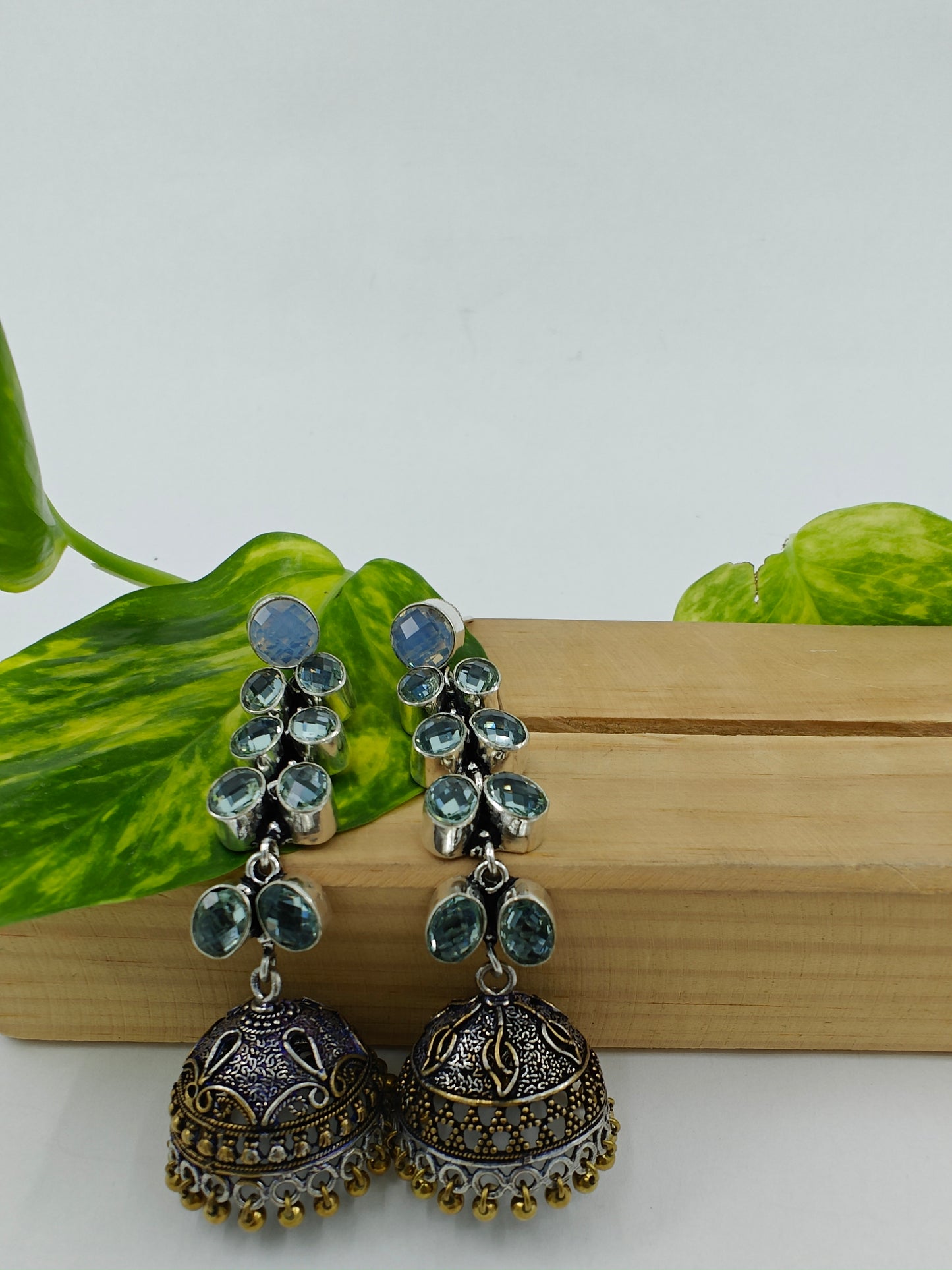 Silver/dual tone finish hanging jhumkis (earrings)on leaf dangler with stones