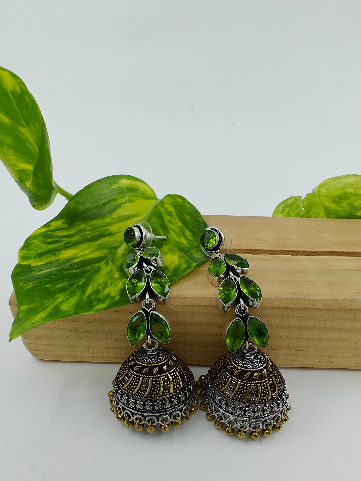 Silver/dual tone finish hanging jhumkis (earrings)on leaf dangler with stones