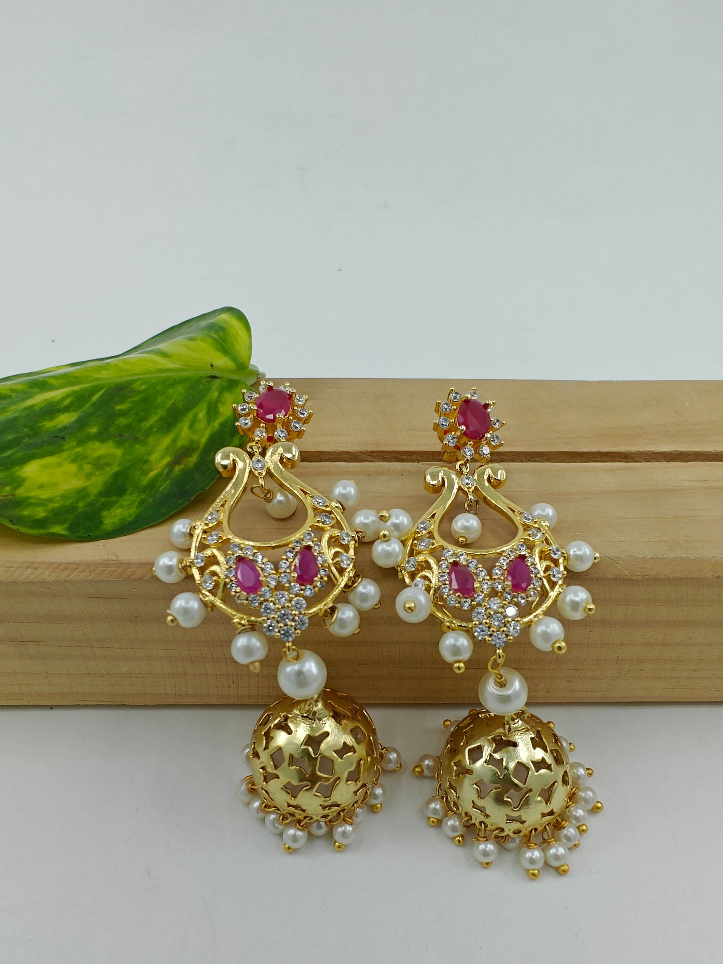 Golden jhumkis(earrings) with pink stone and pearls