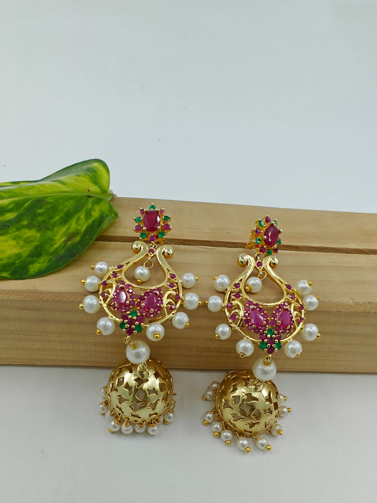 Golden jhumkis(earrings) with pink stone and pearls