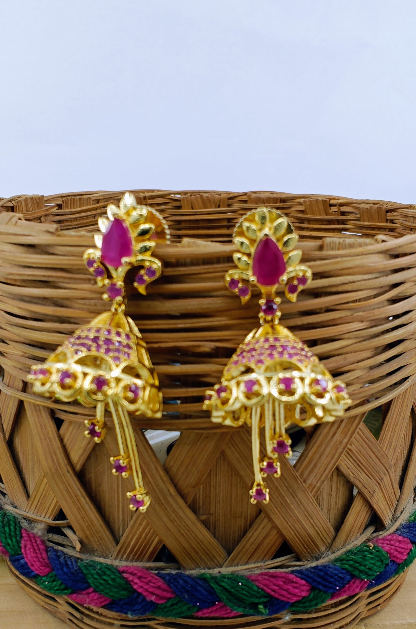 Delicate golden Jhumkis( earrings) with pink stone/clear stone