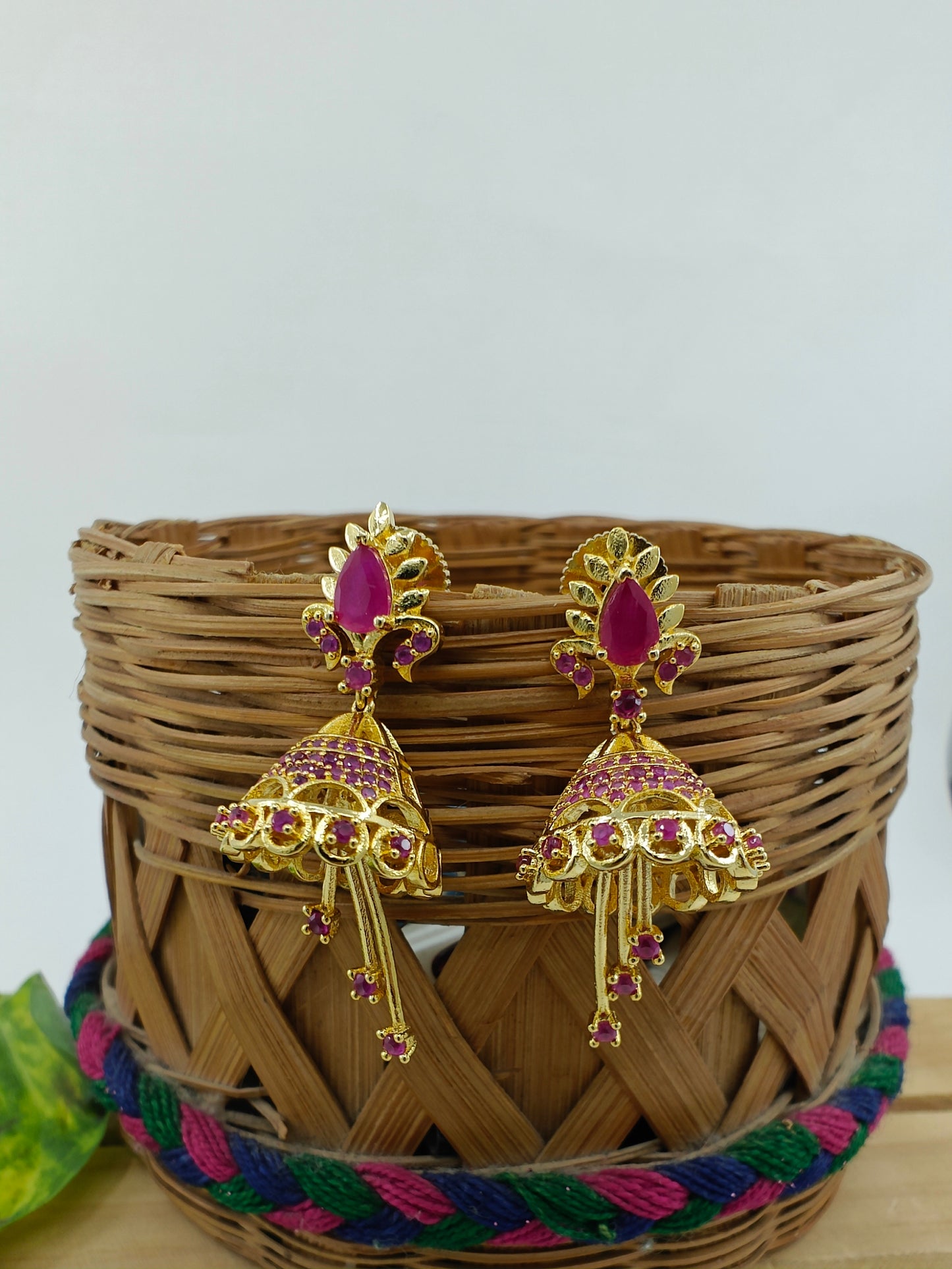 Delicate golden Jhumkis( earrings) with pink stone/clear stone