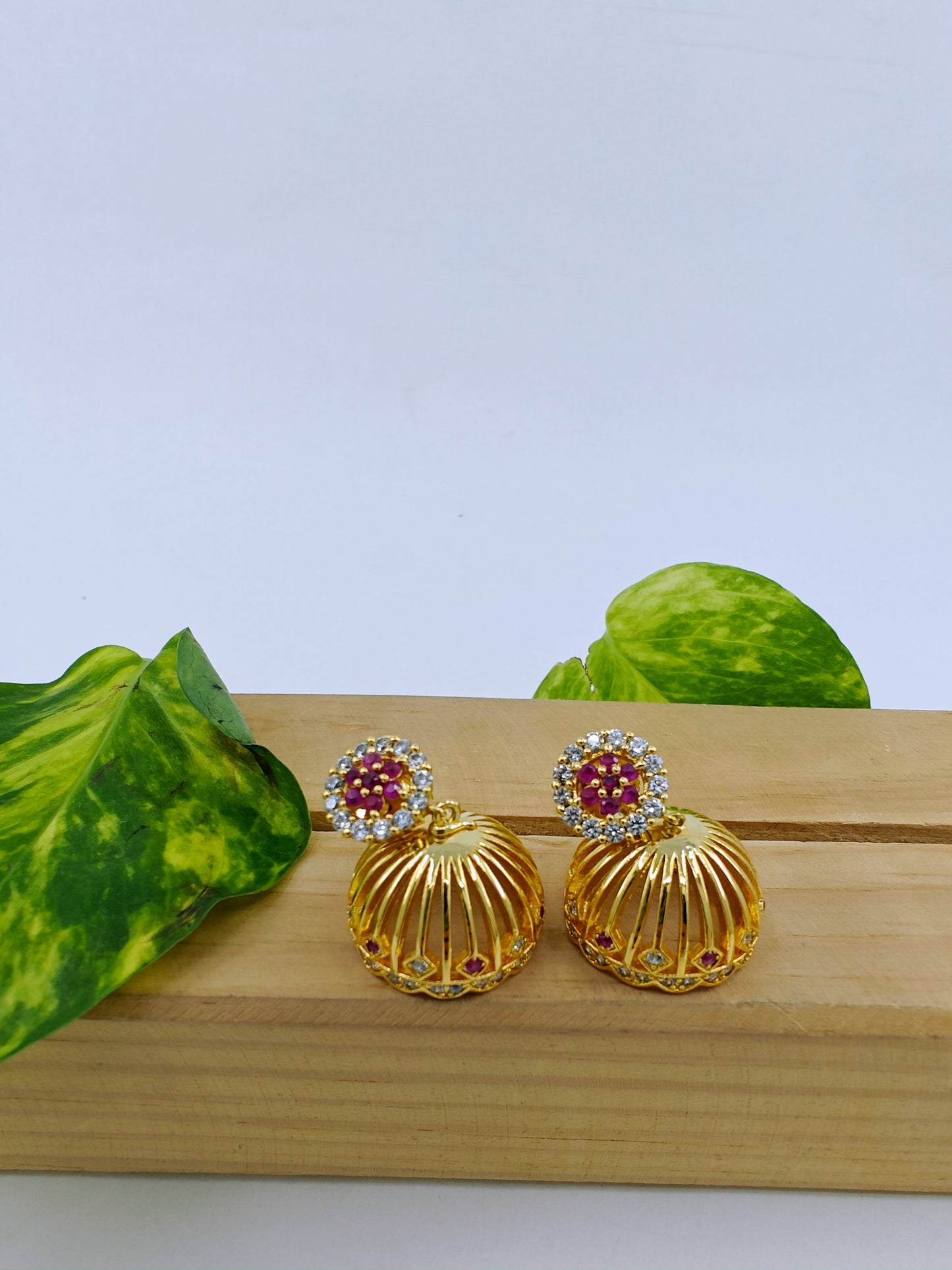 Golden Jhumkis (earrings) with pink work on stud,dome shaped jhumkis at bottom