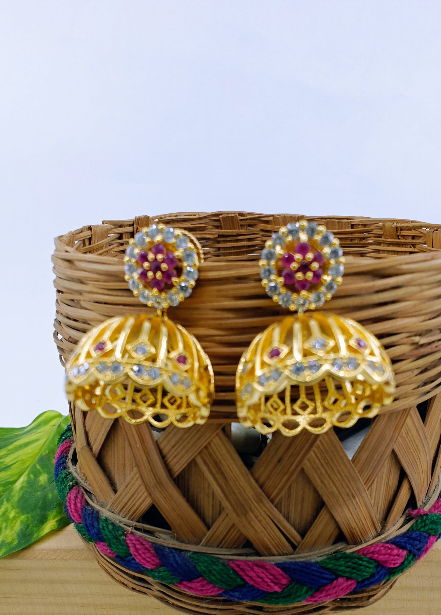 Golden Jhumkis (earrings) with pink work on stud,dome shaped jhumkis at bottom