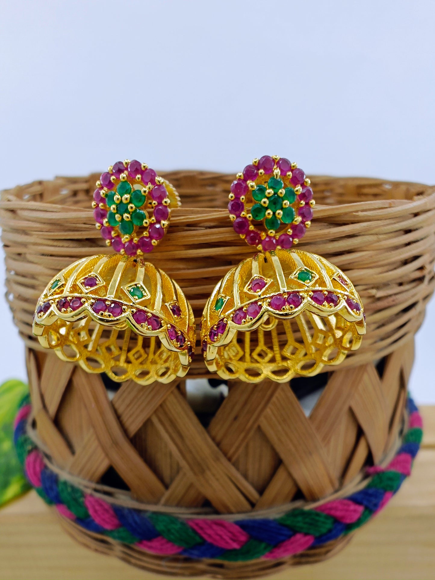 Golden Jhumkis (earrings) with pink work on stud,dome shaped jhumkis at bottom