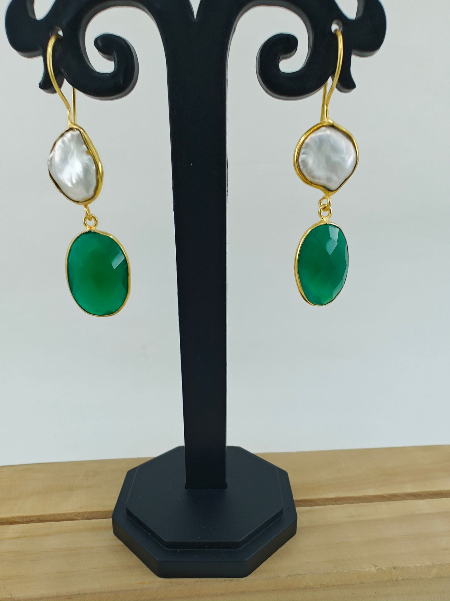 Golden danglers(earrings) with baraque pearl on top and green stone at the bottom