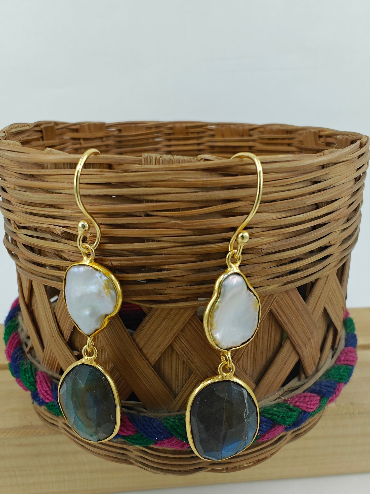 Golden danglers (earrings) with a baraque pearl on top and labradorite stone at bottom