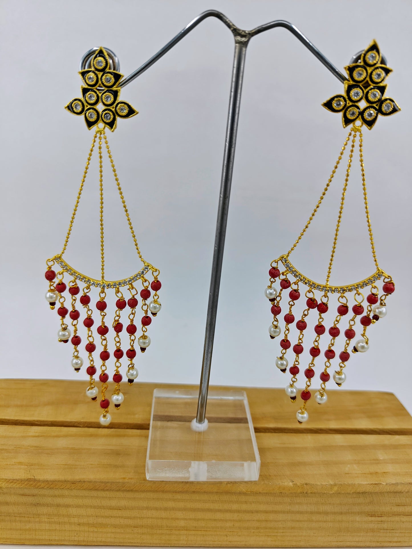 Earrings in gold finish, delicate long danglers with black meenakari and stone hangings