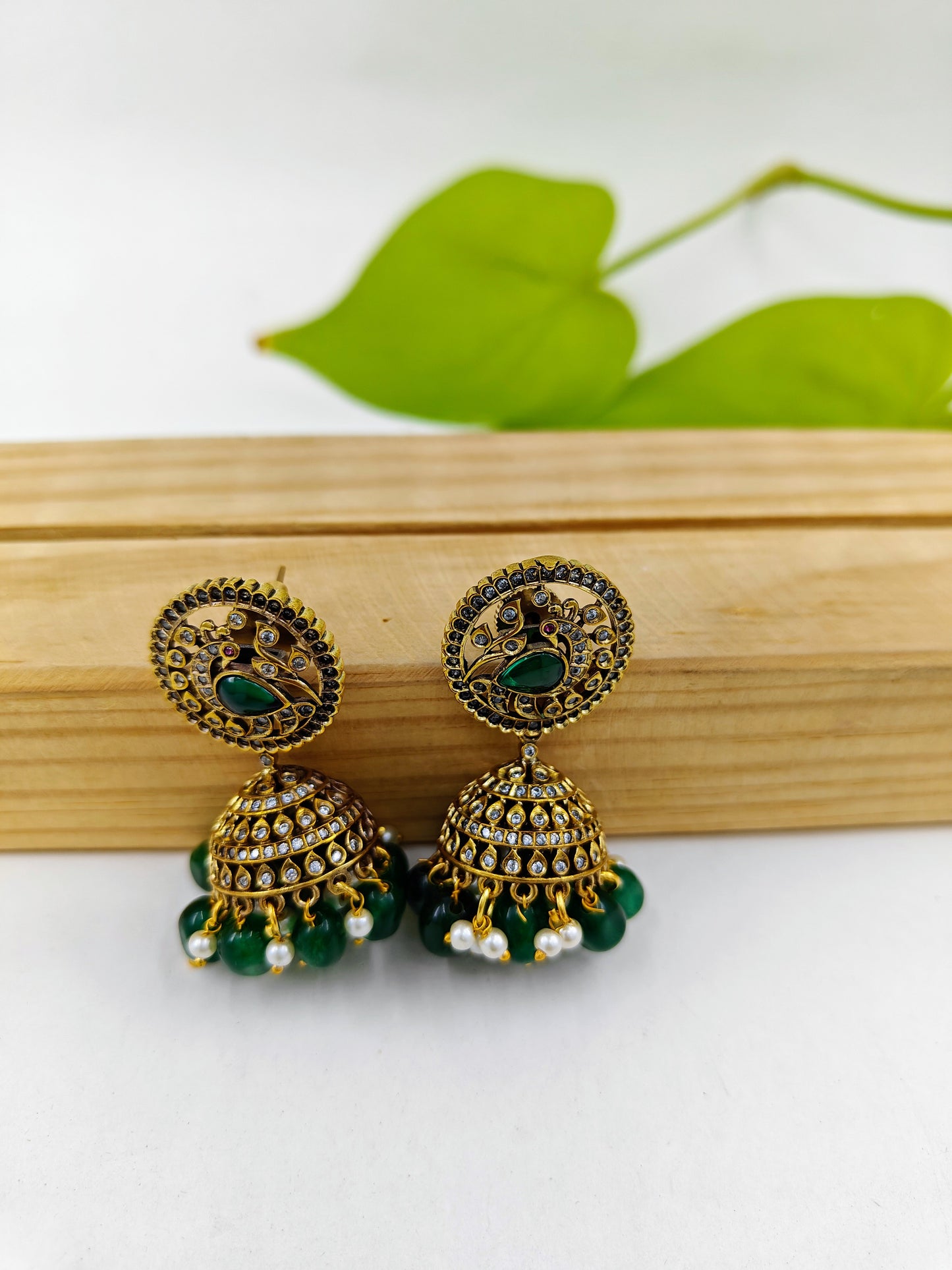 Antique  jhumkis( earrings)with green stone hangings and a  peacock design on round stud