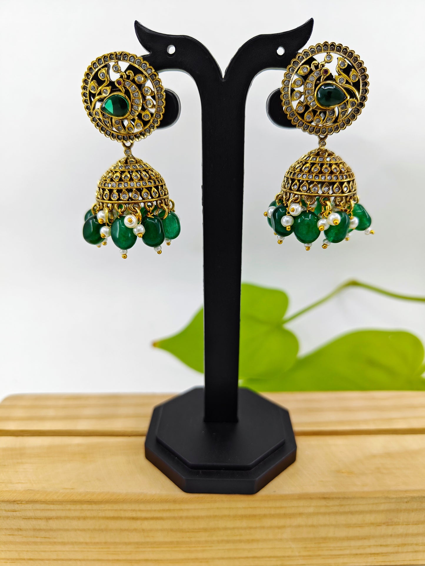 Antique  jhumkis( earrings)with green stone hangings and a  peacock design on round stud