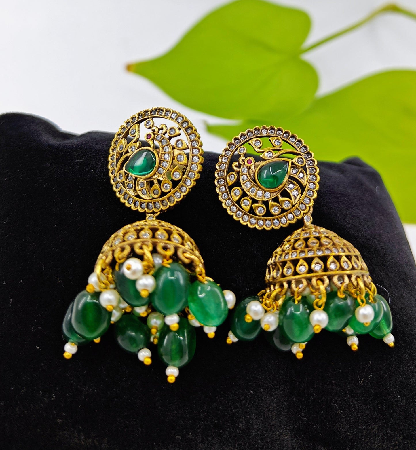 Antique  jhumkis( earrings)with green stone hangings and a  peacock design on round stud