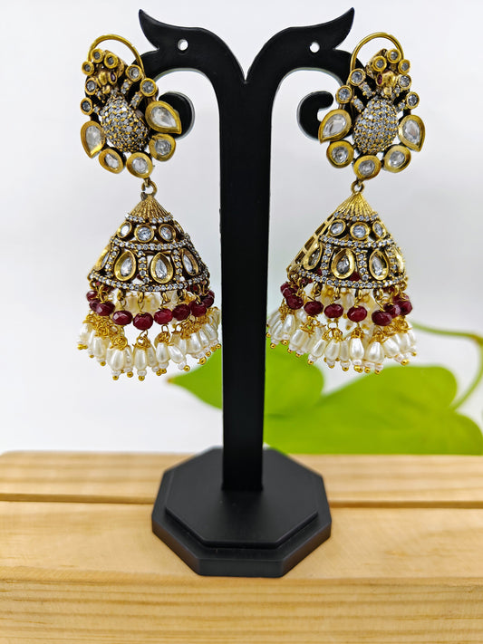 Antique jhumkas with Kundan and peacock stud,Jhumkas have kundan,pearls and red/ green stone hangings