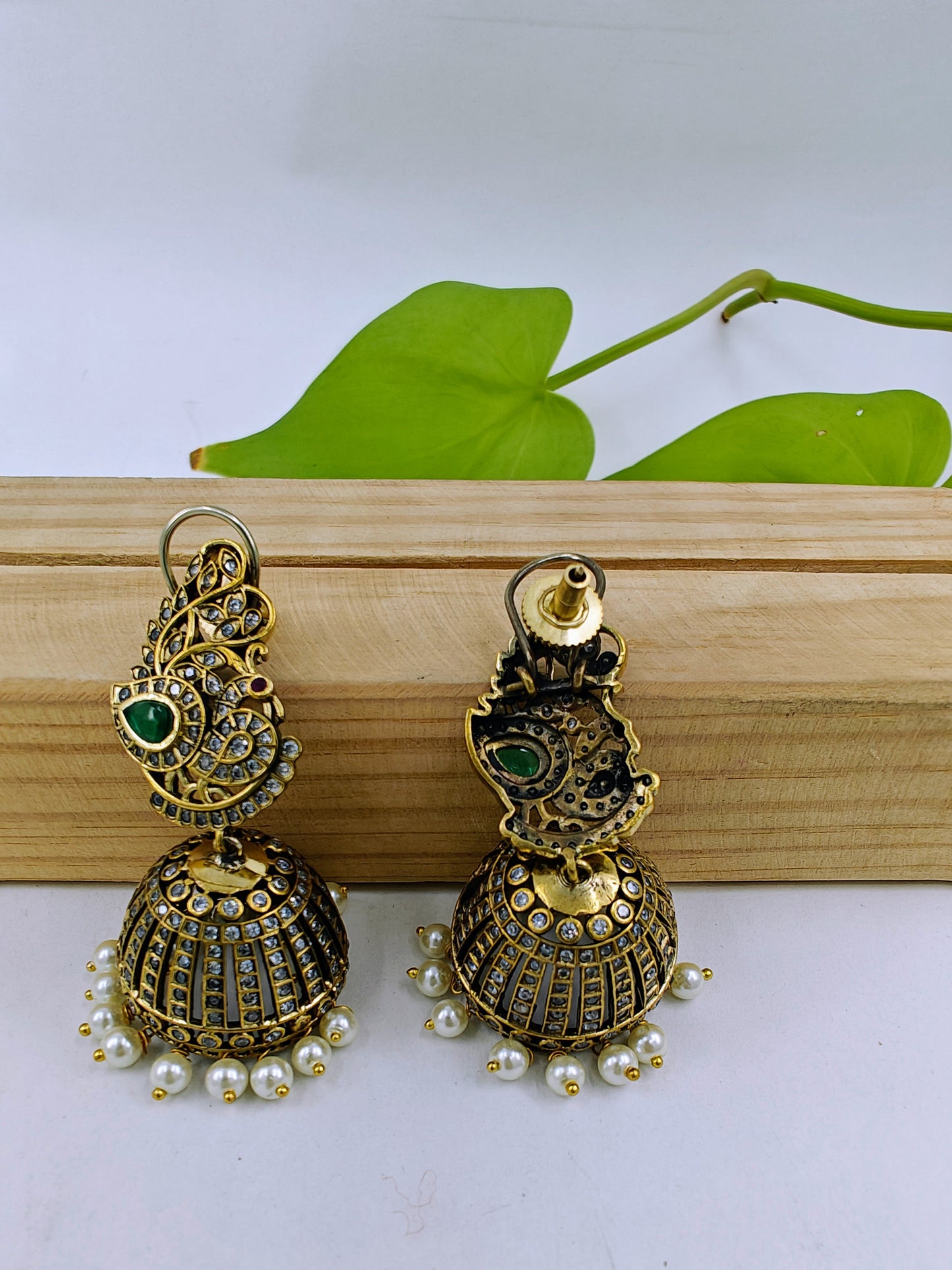 Antique jhumkis(earrings) with pearl hangings and peacock design on stud with green stone