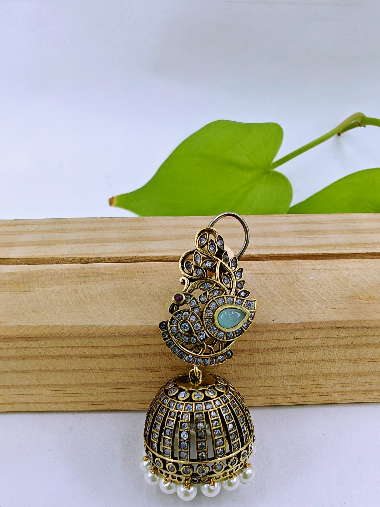 Antique jhumkis(earrings) with pearl hangings and peacock design on stud with green stone