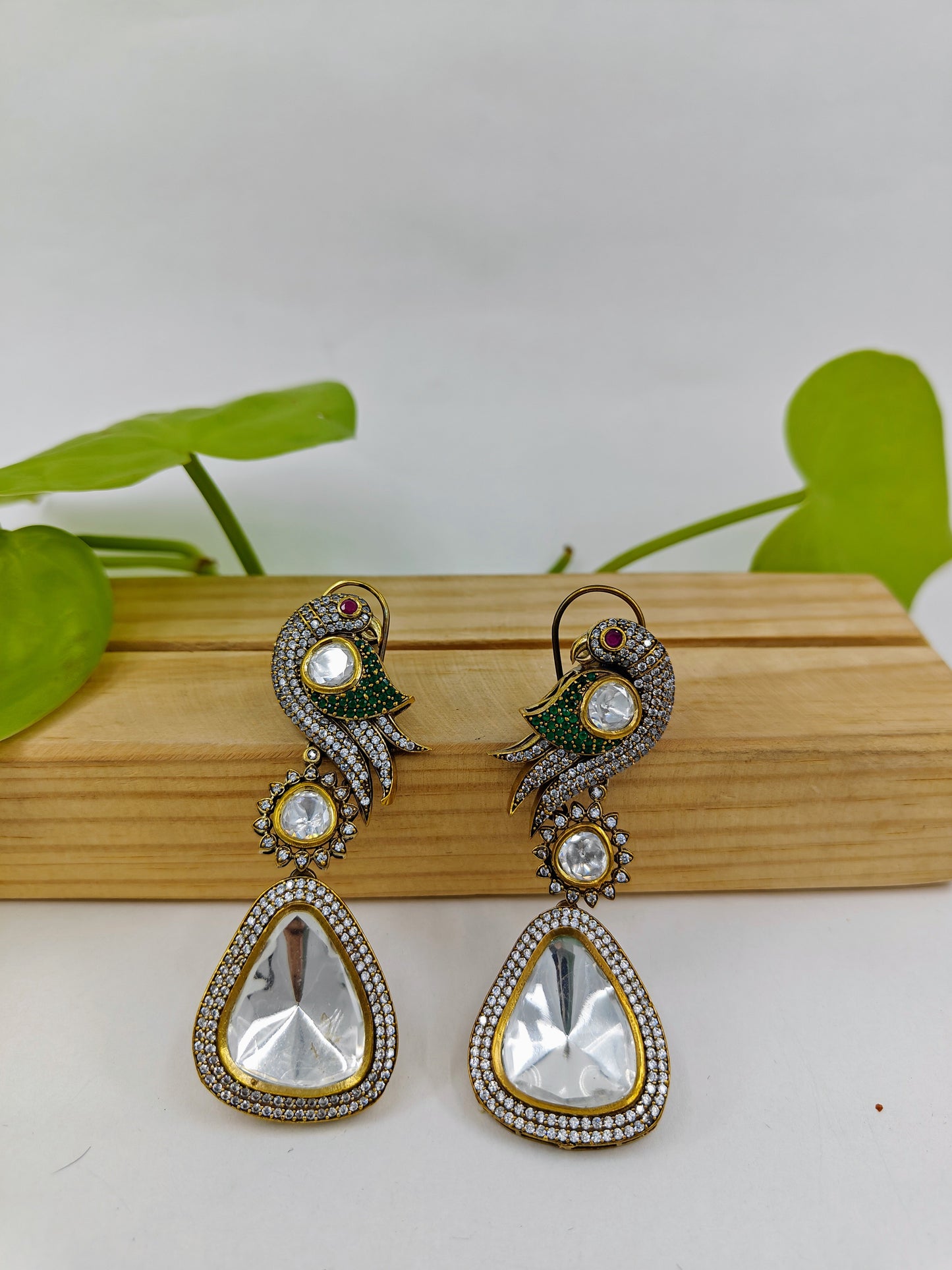 Kundan earrings in antique finish with a parrot on the stud and a big kundan hanging stone