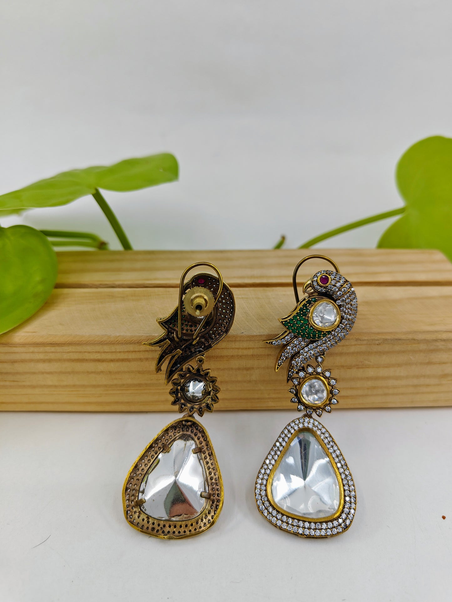 Kundan earrings in antique finish with a parrot on the stud and a big kundan hanging stone