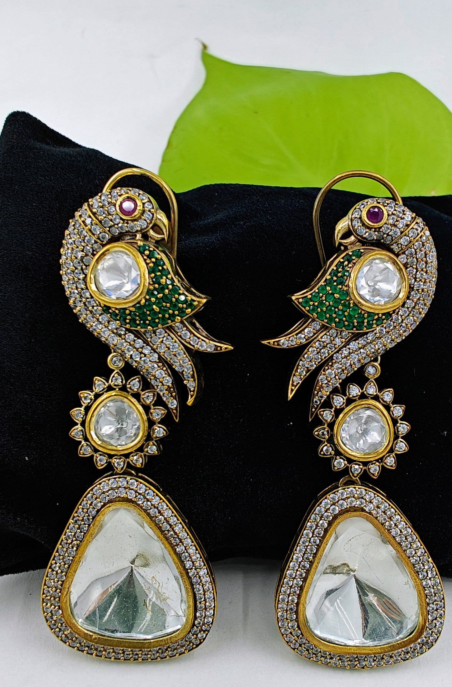 Kundan earrings in antique finish with a parrot on the stud and a big kundan hanging stone