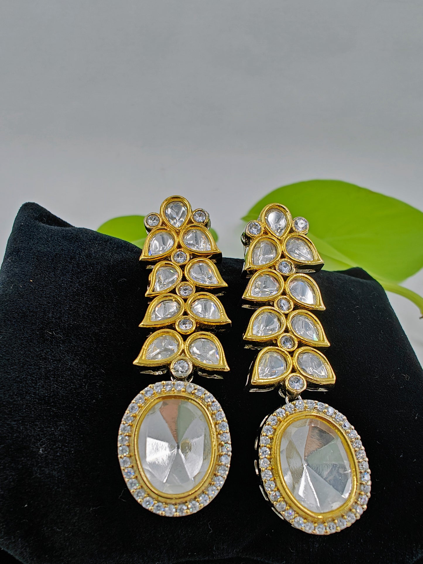 Long Kundan earrings with oval kundan hanging on kundan leaf twig