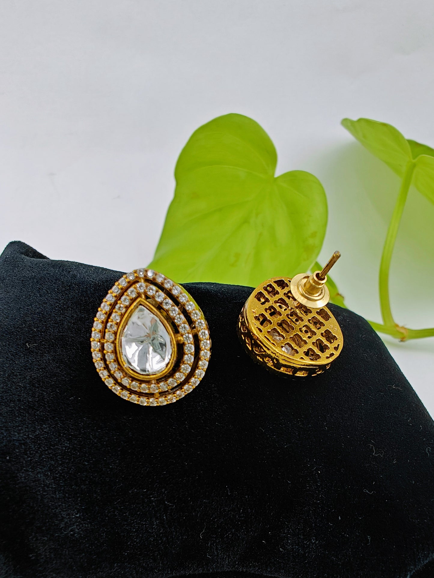 Antique studs( earrings) in matt gold finish with tear drop kundan surrounded by CZ