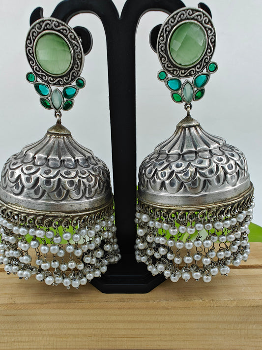 Big Jhumkas (earrings)with green stone on stud and hanging pearls at the botton