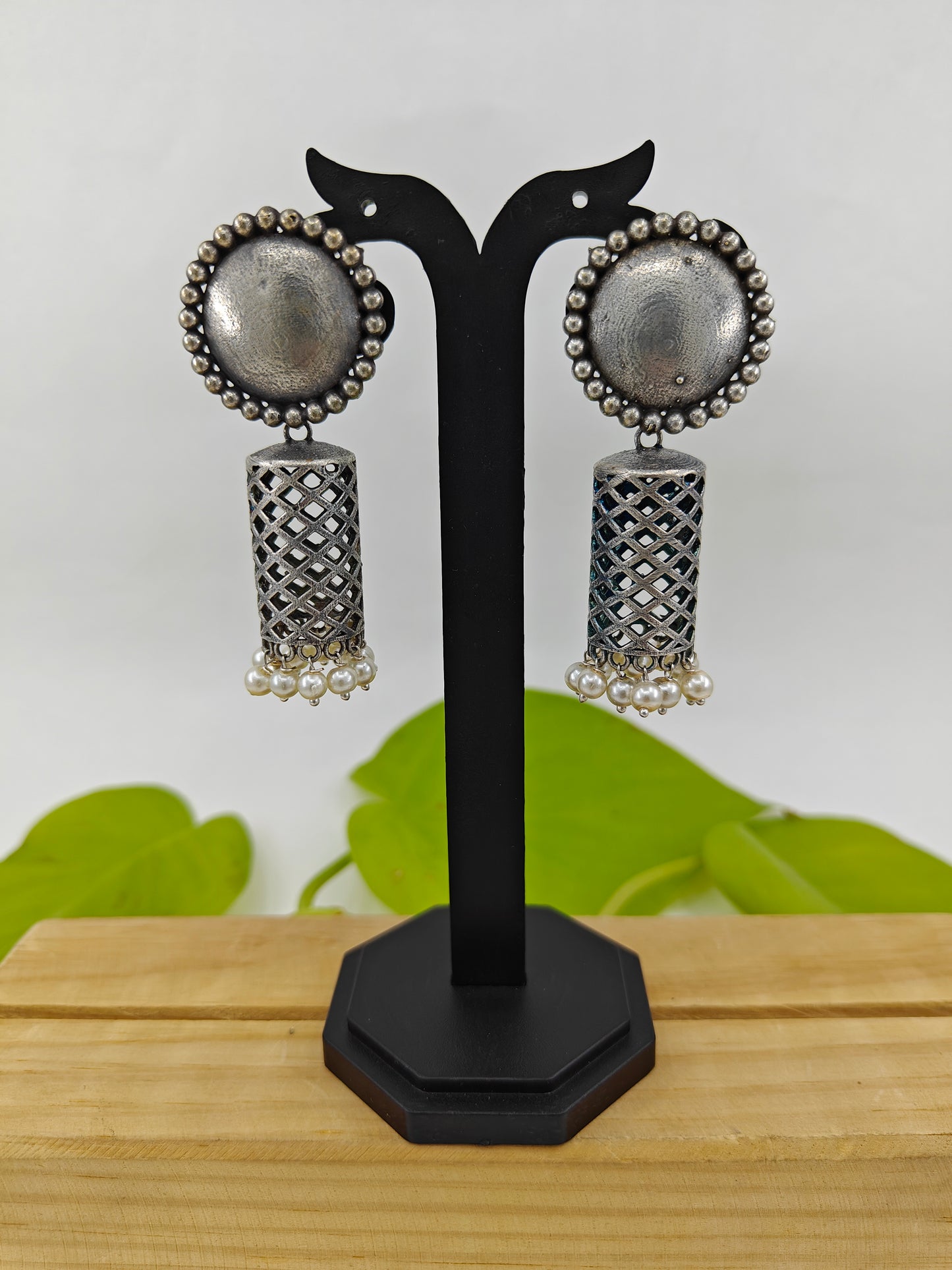 Earrings(jhumkis)in silver finish in cylindrical shape with pearl hangings