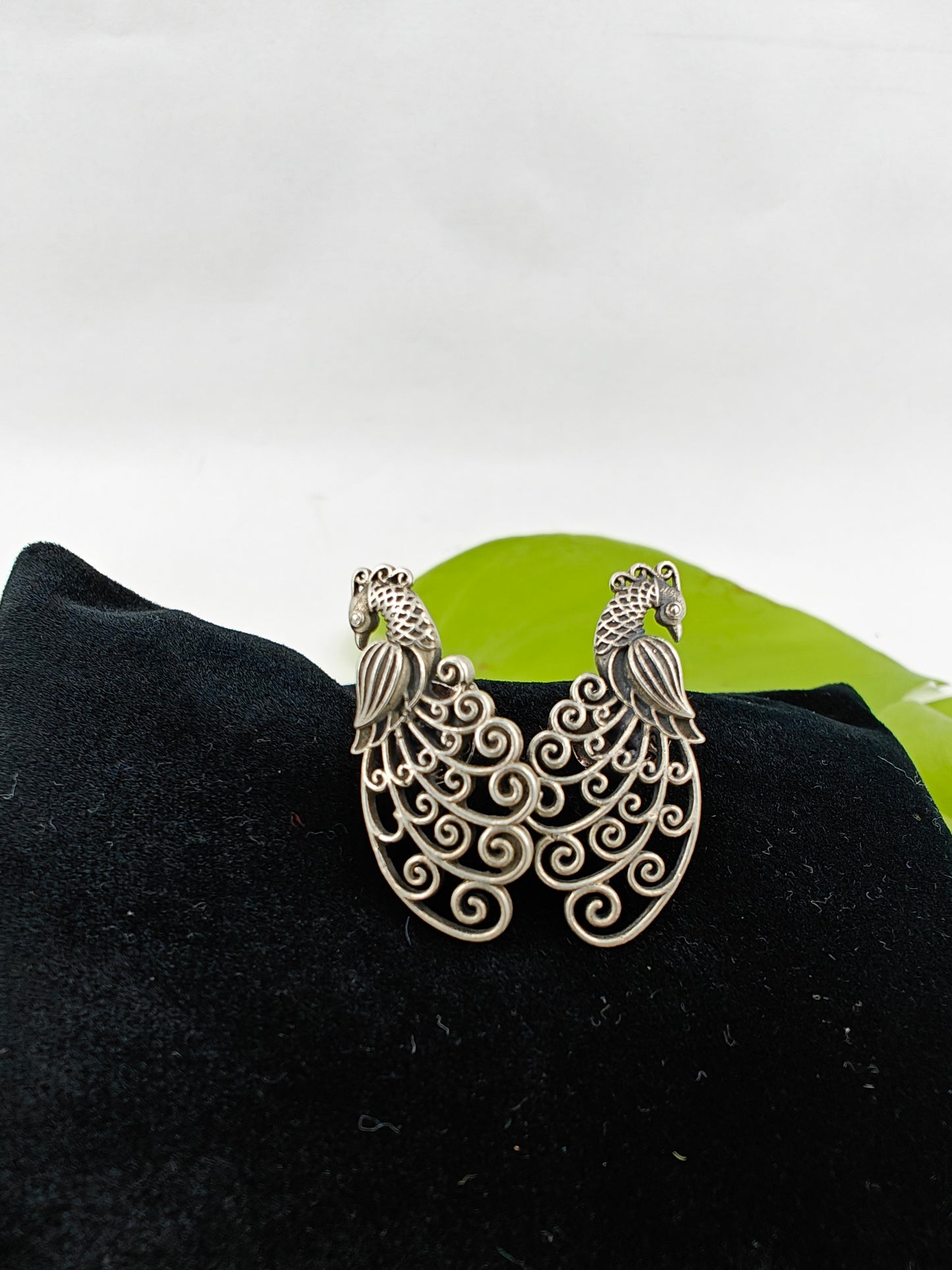 Silver peacock stud (earrings) with intricate jali work