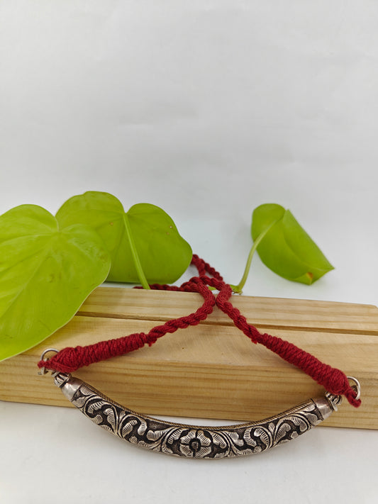 Silver choker hasli (necklace) with floral carving on a maroon thread