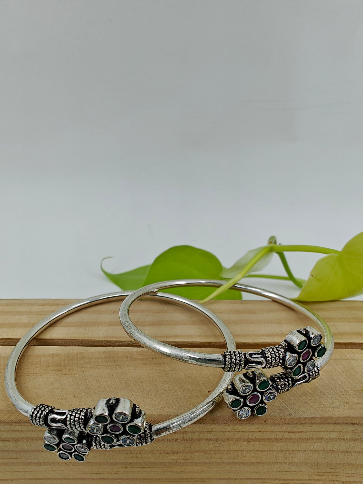 Silver pipe bangles with green,clear stone and pink stone in flower design(2pcs)