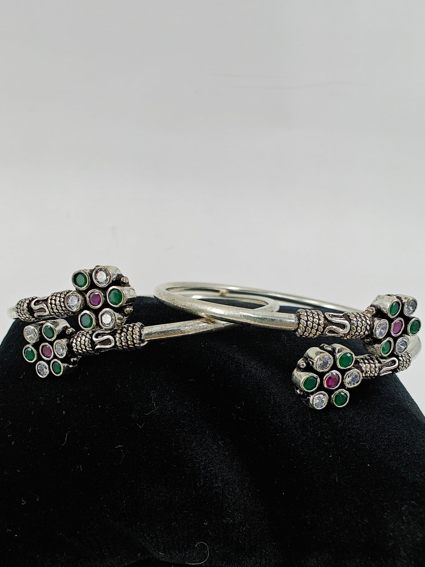 Silver pipe bangles with green,clear stone and pink stone in flower design(2pcs)