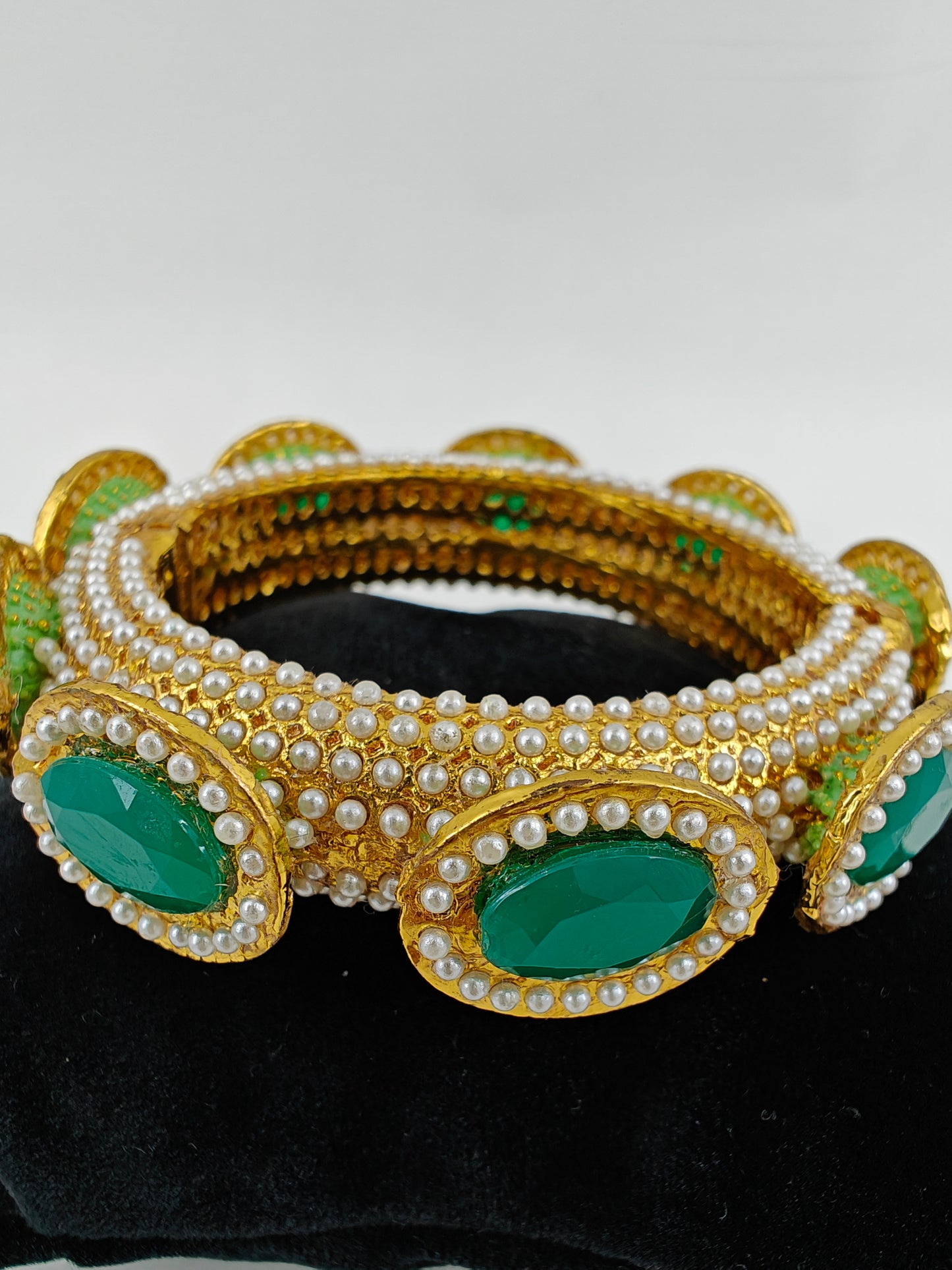 Rajwada Kara( bangle) in gold finish with jadau pearl stone all over, green stones on top