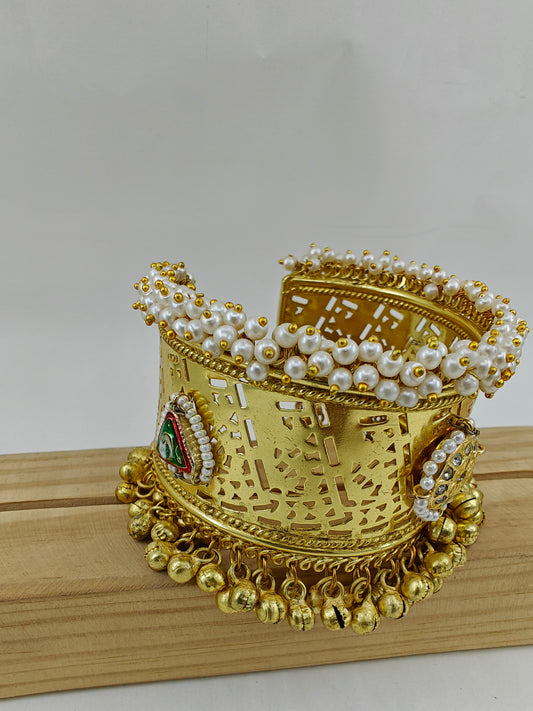 Kuff with gold finish with kundan and pearl work.