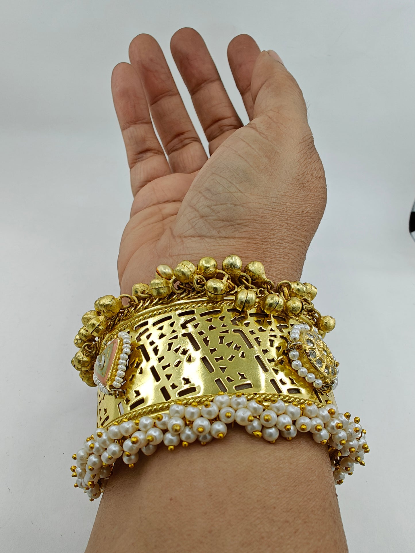 Kuff with gold finish with kundan and pearl work.