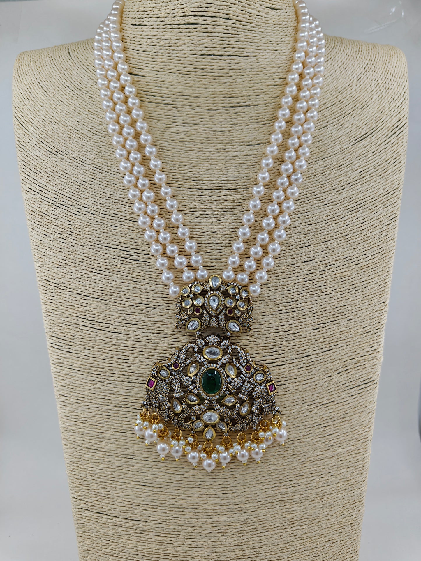 Antique finish set with a big pendant with elephant motif on a smaller piece with peacock motif set on pearl strands,matching earrings