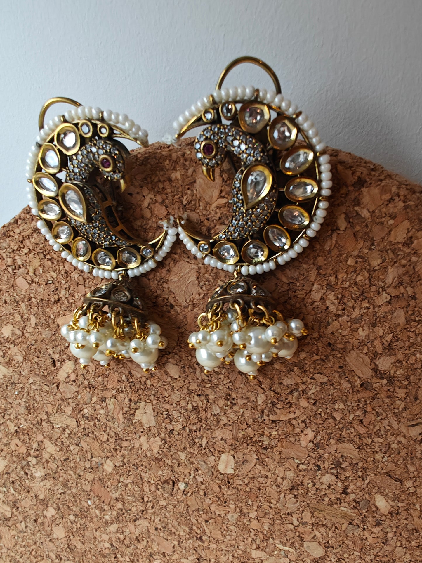 'Chaand-mor' jhumki earrings featuring a peacock nestled in a cresent