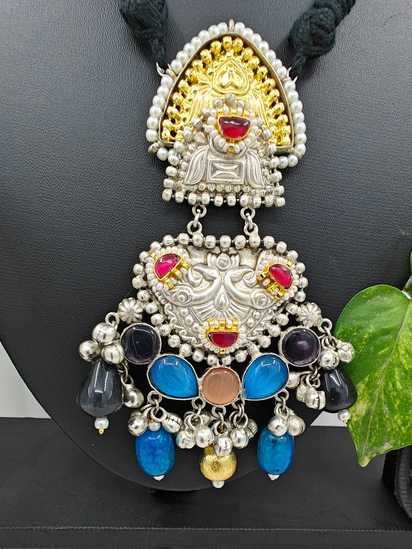 Tilism necklace in black thread with a dual tone pendant with multicolour big stones,kundan,pearl work and ghungroo