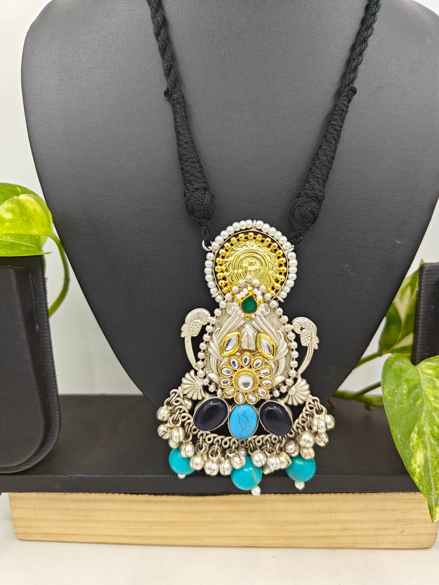 Tilism necklace in black thread with a dual tone pendant with multicolour big stones,kundan,pearl work and ghungroo