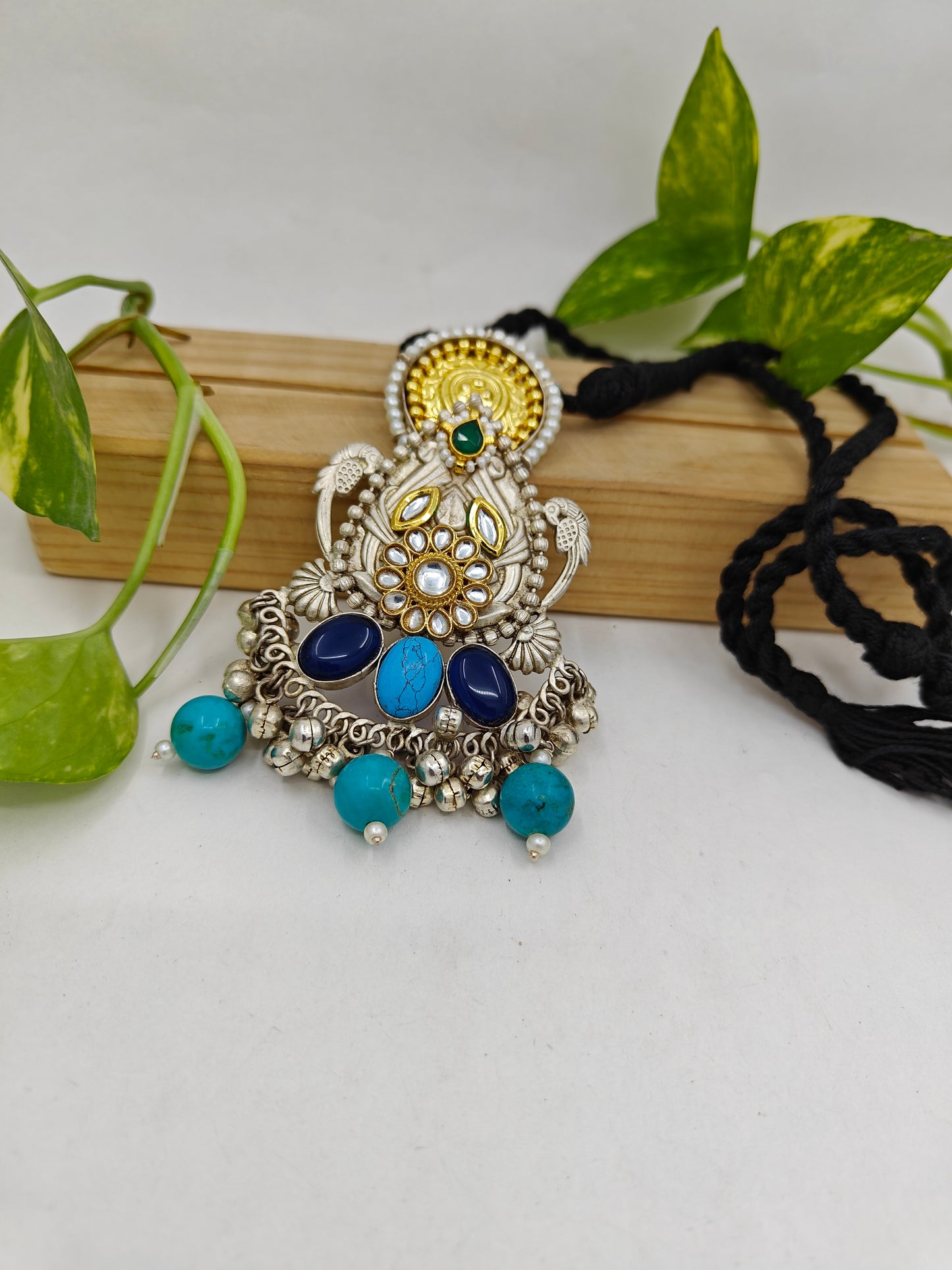 Tilism necklace in black thread with a dual tone pendant with multicolour big stones,kundan,pearl work and ghungroo